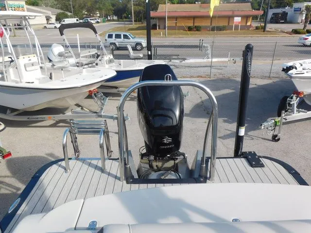 Slide: The Image of Rear view of a 2020 Avalon Ambassador Funship 27' with outboard motor. - 13