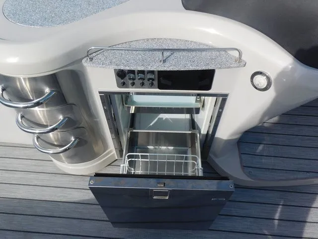 Slide: The Image of Kitchen area of Avalon Ambassador Funship 27' 2020 with open refrigerator. - 9