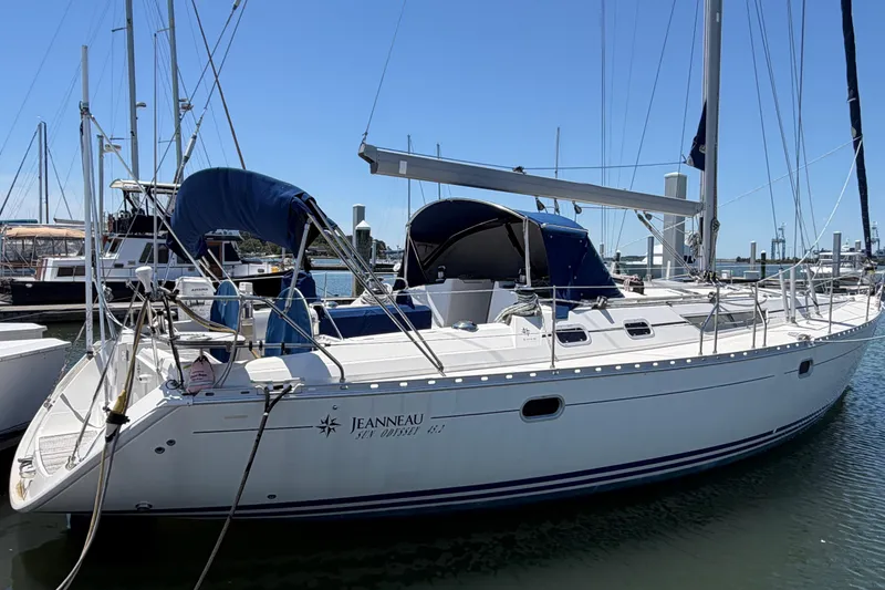 The Image of 1998 Jeanneau Sun Odyssey 45.2 sailboat docked at marina, clear sky background. - 0