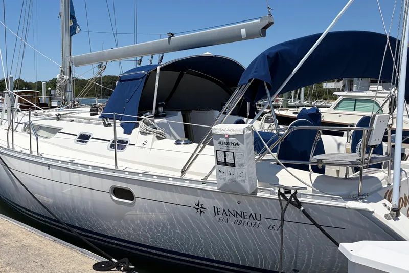 Slide: The Image of Jeanneau Sun Odyssey 45.2 sailboat docked, 1998 model, with blue canopy and sleek design. - 1