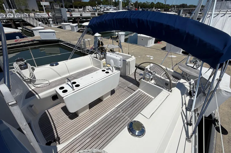 Slide: The Image of Jeanneau Sun Odyssey 45.2 sailboat cockpit, 1998 model, docked at marina with blue canopy. - 13