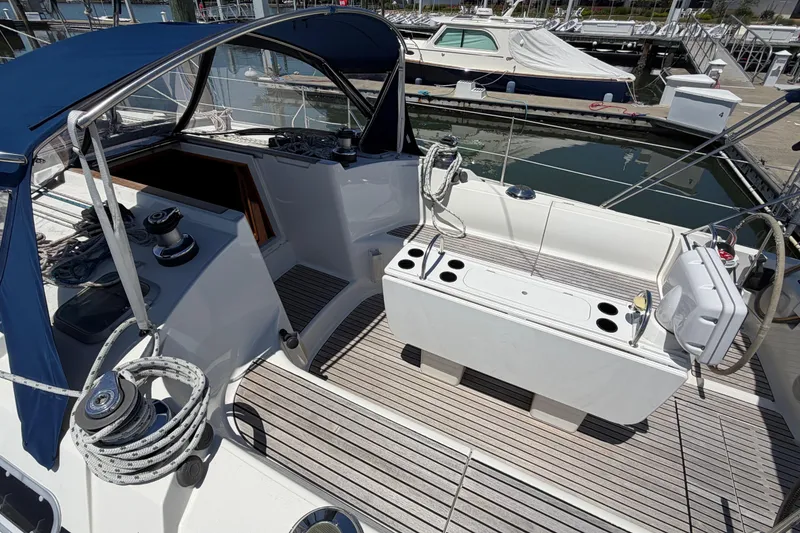 Slide: The Image of Cockpit of 1998 Jeanneau Sun Odyssey 45.2 sailboat with blue canopy and wooden deck. - 14