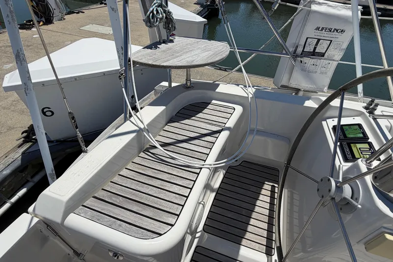 Slide: The Image of Cockpit of 1998 Jeanneau Sun Odyssey 45.2 sailboat with wooden seating and navigation equipment. - 19