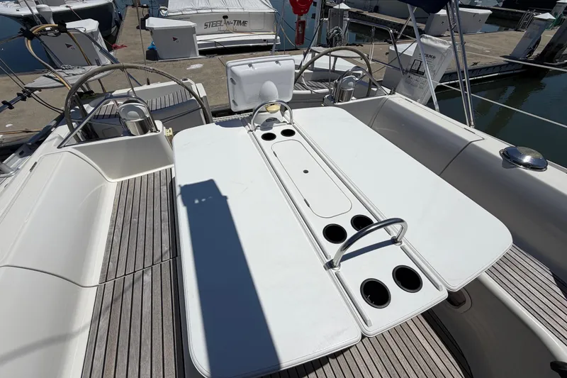 Slide: The Image of Cockpit of 1998 Jeanneau Sun Odyssey 45.2 sailboat with dual steering wheels and seating. - 21