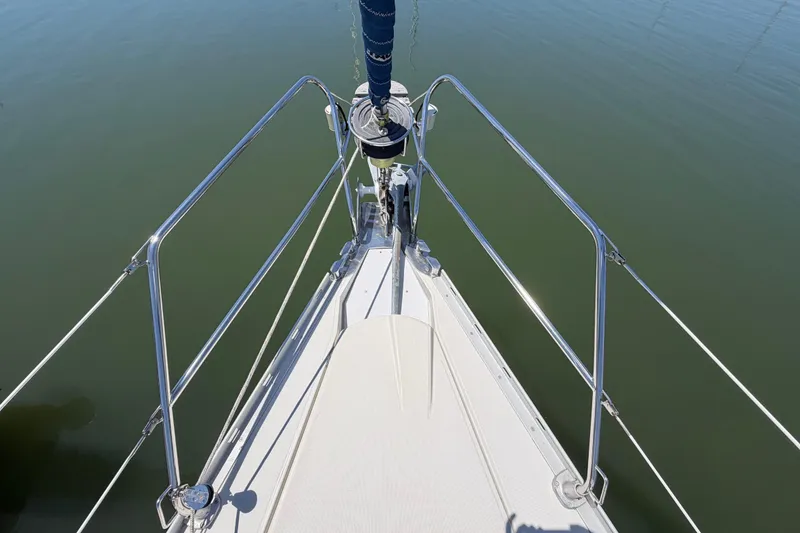 Slide: The Image of Bow view of 1998 Jeanneau Sun Odyssey 45.2 sailboat on calm water. - 3