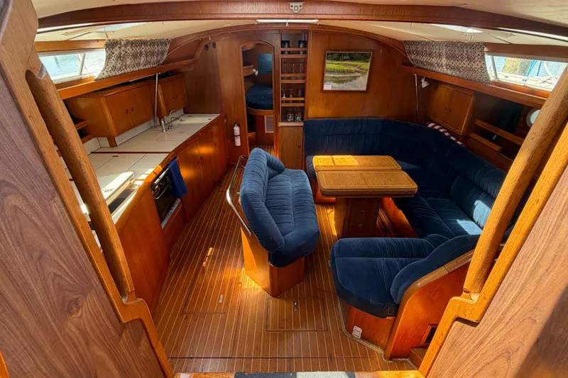 Slide: The Image of Interior of 1998 Jeanneau Sun Odyssey 45.2 yacht with cozy seating and wooden finishes. - 33