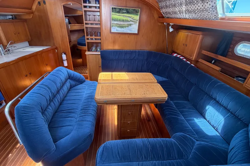 Slide: The Image of Luxurious interior of 1998 Jeanneau Sun Odyssey 45.2 yacht with blue seating and wooden table. - 35