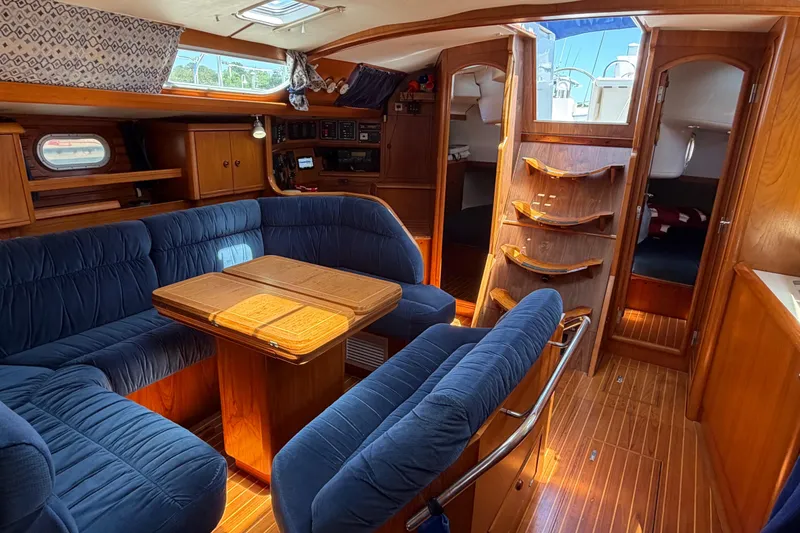 Slide: The Image of Interior of 1998 Jeanneau Sun Odyssey 45.2 sailboat with blue seating and wooden finishes. - 37