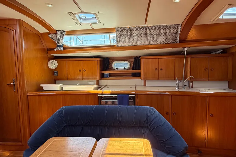 Slide: The Image of Interior of 1998 Jeanneau Sun Odyssey 45.2 yacht with wooden cabinetry and blue seating. - 39