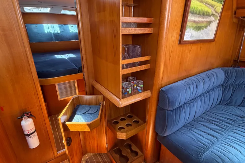 Slide: The Image of Interior of 1998 Jeanneau Sun Odyssey 45.2 yacht with wooden cabinetry and blue seating. - 41