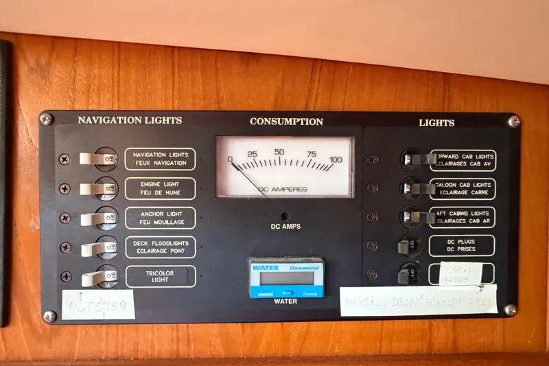 Slide: The Image of Control panel of a 1998 Jeanneau Sun Odyssey 45.2 sailboat, featuring navigation and cabin light switches. - 50
