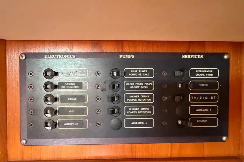 Slide: The Image of Control panel of a 1998 Jeanneau Sun Odyssey 45.2 yacht, featuring electronics, pumps, and services. - 51