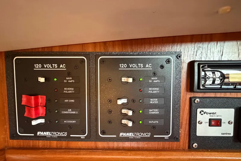 Slide: The Image of Electrical panel on a 1998 Jeanneau Sun Odyssey 45.2 sailboat, featuring 120 volts AC controls. - 52