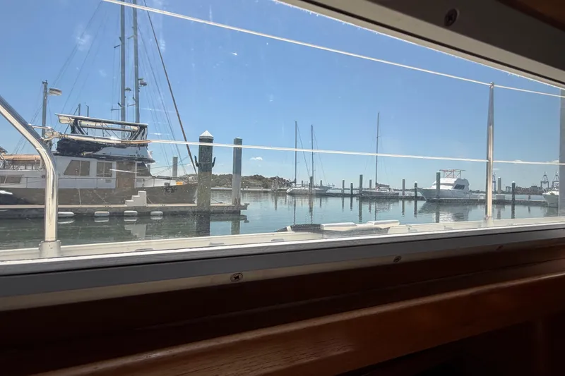 Slide: The Image of View from Jeanneau Sun Odyssey 45.2, 1998, showing marina with sailboats and clear sky. - 54