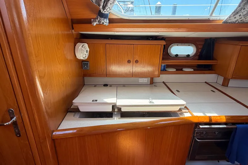 Slide: The Image of Interior of 1998 Jeanneau Sun Odyssey 45.2 yacht kitchen with wooden cabinets and countertop. - 55