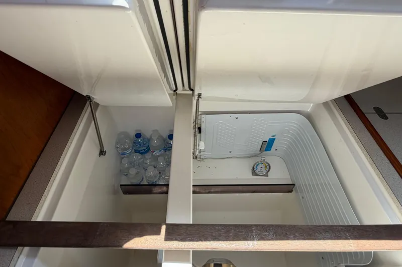 Slide: The Image of Interior storage compartment of 1998 Jeanneau Sun Odyssey 45.2 yacht with water bottles. - 56