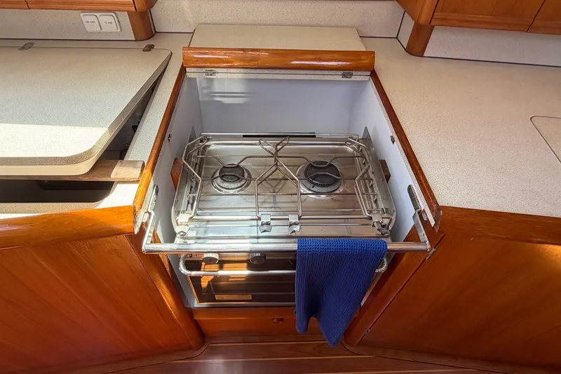 Slide: The Image of Stove in Jeanneau Sun Odyssey 45.2 yacht kitchen, 1998 model, with wooden cabinetry. - 60