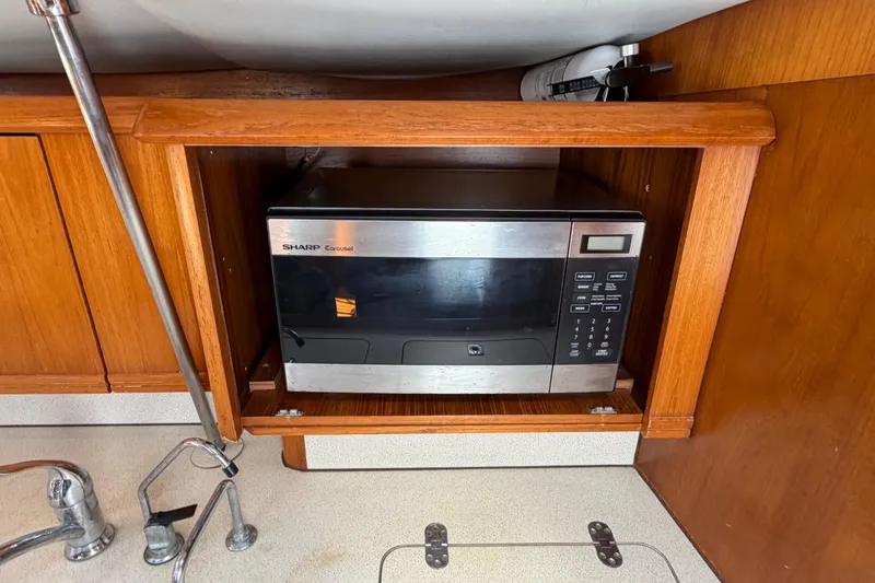 Slide: The Image of Microwave in Jeanneau Sun Odyssey 45.2 yacht kitchen, 1998 model, wooden cabinetry. - 63