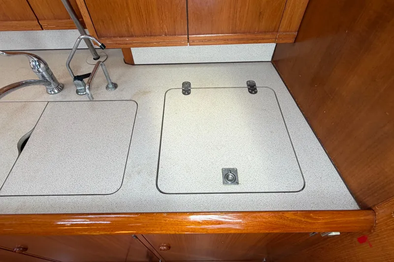 Slide: The Image of Galley countertop of 1998 Jeanneau Sun Odyssey 45.2 sailboat with sink and storage. - 64