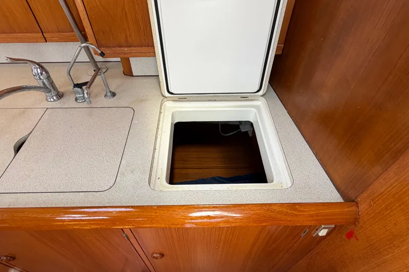Slide: The Image of Interior of 1998 Jeanneau Sun Odyssey 45.2 yacht showing kitchen sink and storage compartment. - 65