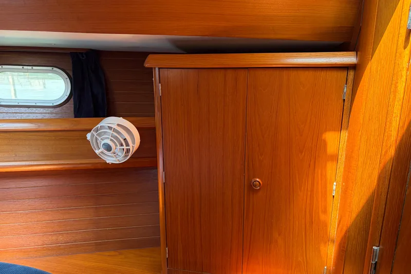 Slide: The Image of Interior of 1998 Jeanneau Sun Odyssey 45.2 yacht with wooden cabinetry and porthole. - 71
