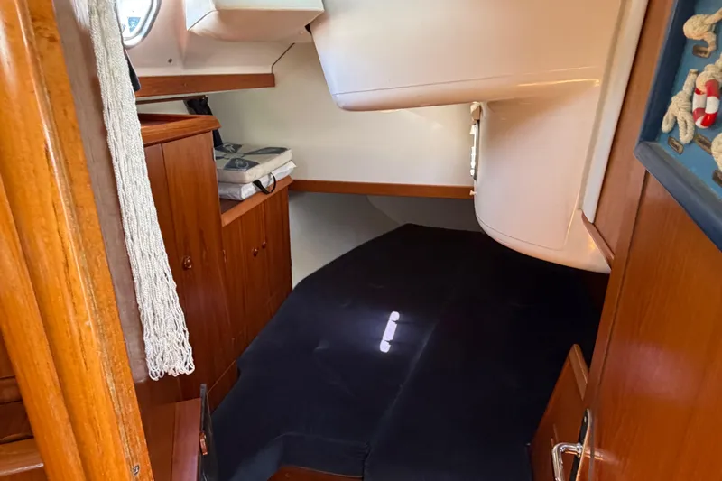 Slide: The Image of Cozy cabin interior of 1998 Jeanneau Sun Odyssey 45.2 sailboat with wooden cabinetry. - 76