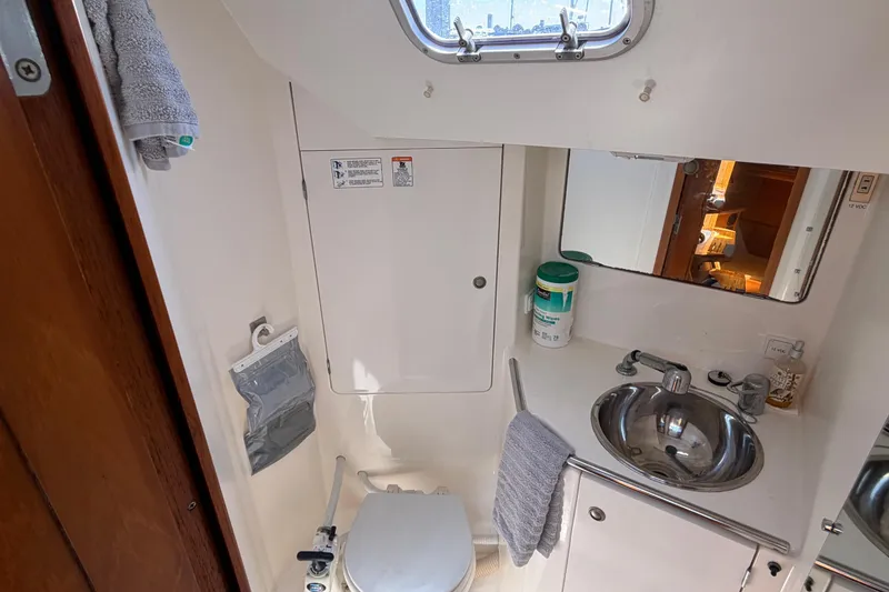 Slide: The Image of Bathroom interior of 1998 Jeanneau Sun Odyssey 45.2 yacht, featuring sink and toilet. - 78