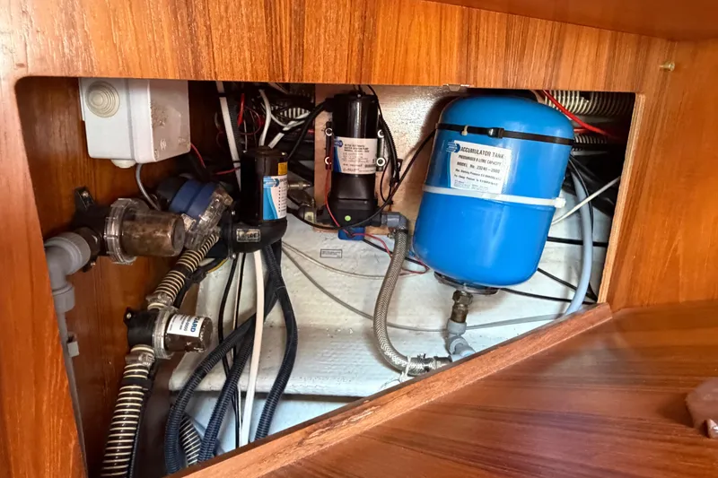 Slide: The Image of Engine compartment of 1998 Jeanneau Sun Odyssey 45.2 sailboat, featuring plumbing and electrical components. - 81