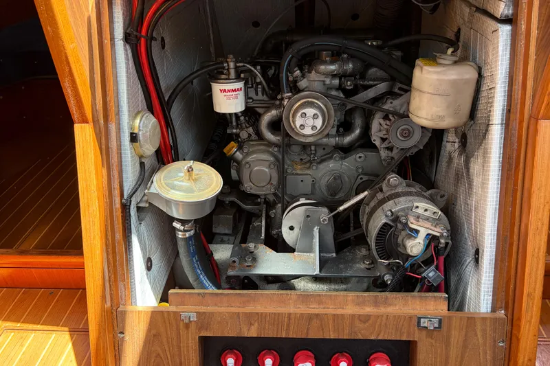 Slide: The Image of Engine compartment of a 1998 Jeanneau Sun Odyssey 45.2 sailboat, featuring a Yanmar engine. - 82