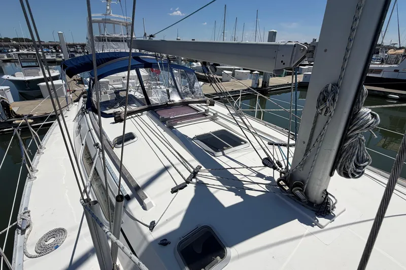 Slide: The Image of 1998 Jeanneau Sun Odyssey 45.2 sailboat docked at marina, showcasing deck and rigging. - 9