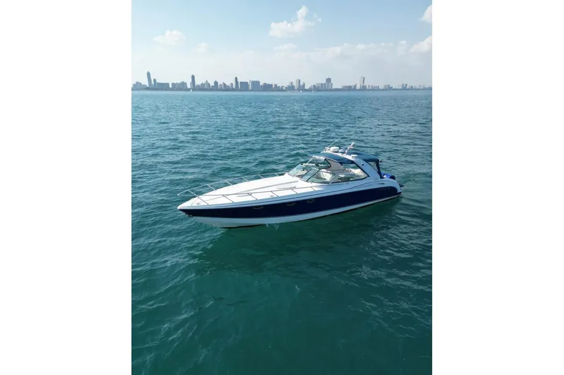The Image of 2003 Formula 400 Super Sport boat on open water with city skyline in background. - 0