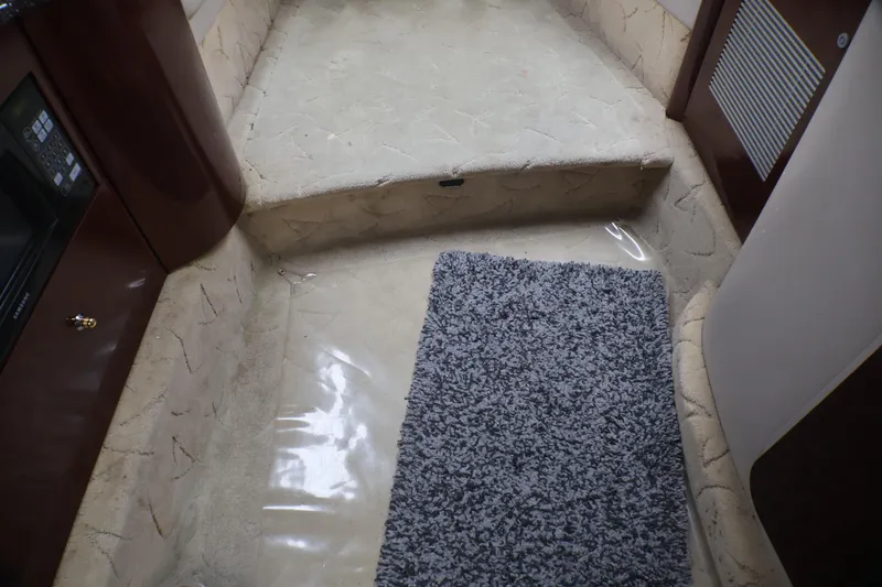Slide: The Image of Interior of 2003 Formula 400 Super Sport boat with carpeted steps and modern design. - 12