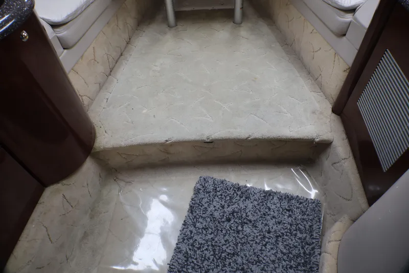 Slide: The Image of Interior of a 2003 Formula 400 Super Sport boat with carpeted steps and seating. - 13