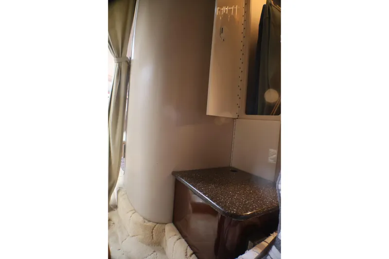Slide: The Image of Interior cabin of 2003 Formula 400 Super Sport boat with countertop and curtain. - 14