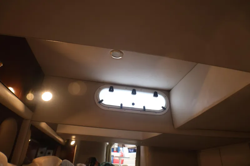 Slide: The Image of Interior cabin view of a 2003 Formula 400 Super Sport boat with porthole window. - 16