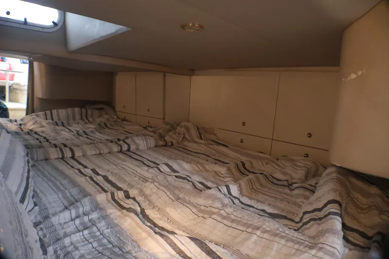 Slide: The Image of Interior cabin of 2003 Formula 400 Super Sport boat with striped bedding. - 18