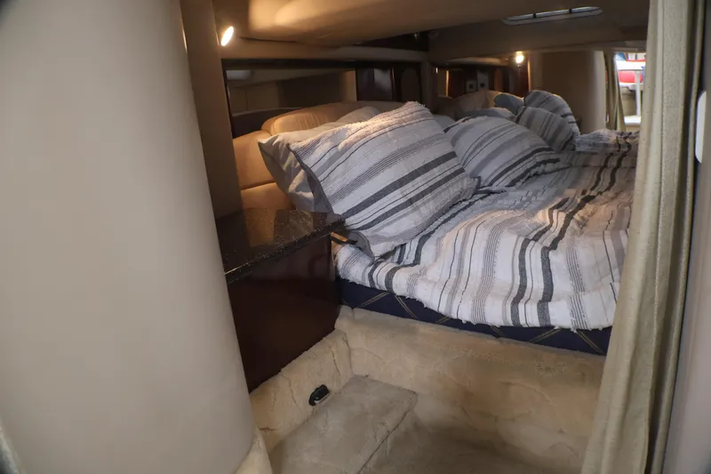 Slide: The Image of Interior cabin of a 2003 Formula 400 Super Sport boat with cozy bedding. - 19