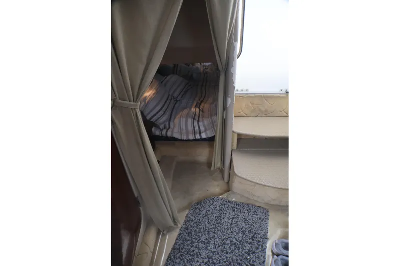 Slide: The Image of Interior cabin view of a 2003 Formula 400 Super Sport boat with cozy bedding. - 20