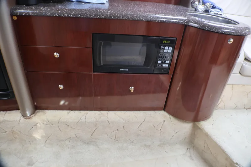 Slide: The Image of Luxury yacht interior with wood cabinetry, microwave, and sink in a 2003 Formula 400 Super Sport. - 26