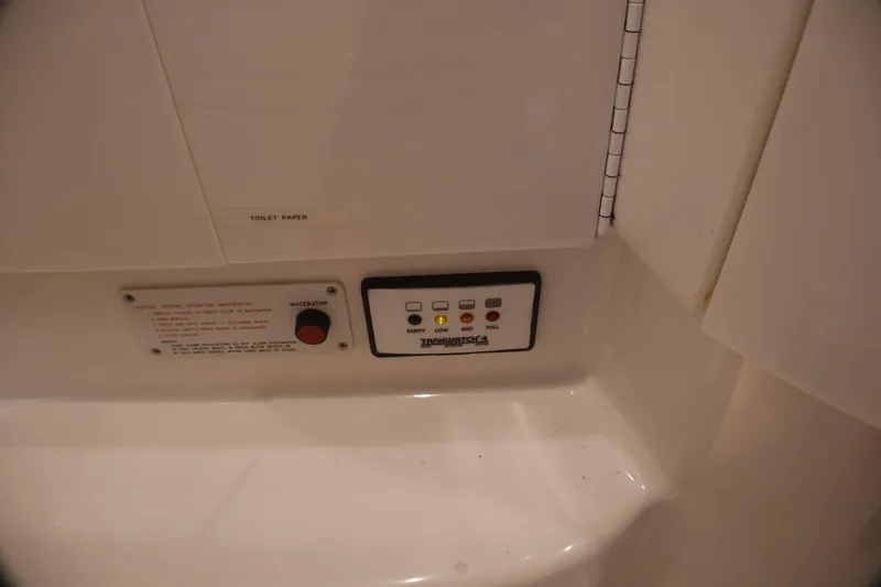 Slide: The Image of Control panel and macerator switch in 2003 Formula 400 Super Sport boat bathroom. - 27