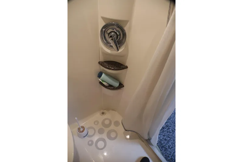 Slide: The Image of Shower area in 2003 Formula 400 Super Sport boat with shelves and curtain. - 29