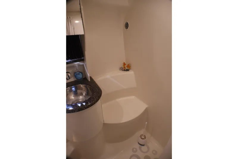 Slide: The Image of Compact bathroom in a 2003 Formula 400 Super Sport boat with sink and shower. - 31