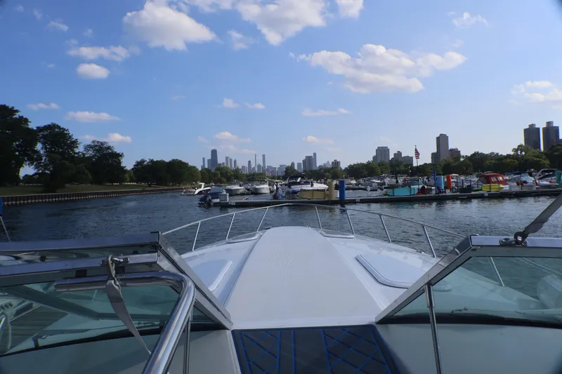Slide: The Image of Bow view from a 2003 Formula 400 Super Sport boat in a marina with city skyline. - 39