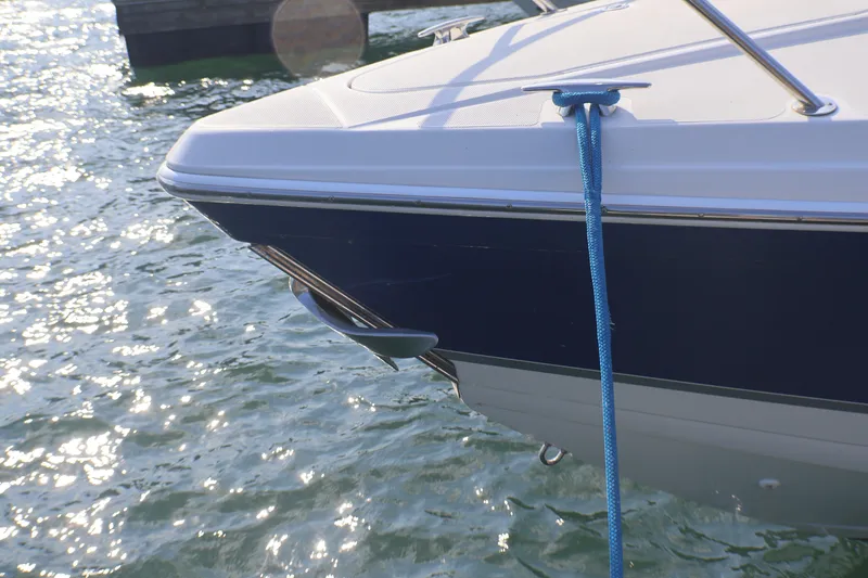 Slide: The Image of 2003 Formula 400 Super Sport boat docked with blue rope on sunny water. - 4