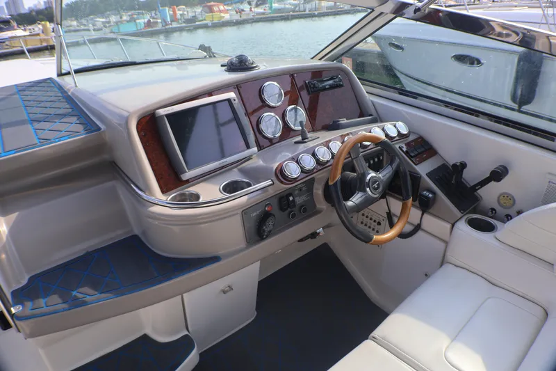 Slide: The Image of 2003 Formula 400 Super Sport boat cockpit with steering wheel and control panel. - 42