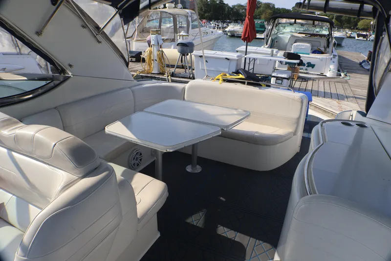 Slide: The Image of 2003 Formula 400 Super Sport yacht interior with white seating and table at marina. - 49
