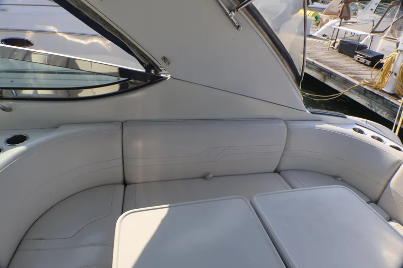 Slide: The Image of 2003 Formula 400 Super Sport boat interior with white seating and cup holders. - 50