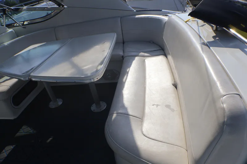 Slide: The Image of 2003 Formula 400 Super Sport boat interior with white seating and table. - 56