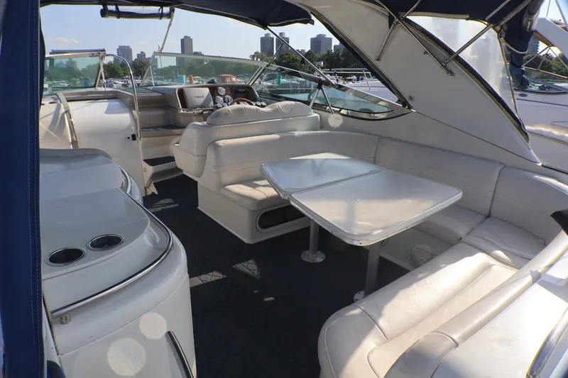 Slide: The Image of Interior of a 2003 Formula 400 Super Sport boat with white seating and table. - 57