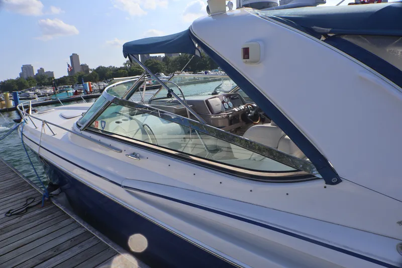 Slide: The Image of 2003 Formula 400 Super Sport boat docked at marina under clear sky. - 7